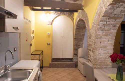 Old Town Apartment | Cozy suite in the heart of Perugia, perfect for 2 guests.Elegant room, comfortable living room and kitchen equipped to feel right at home.The unique detail? The natural stone walls, which give charm and character to the environment.Bright and well-kept,